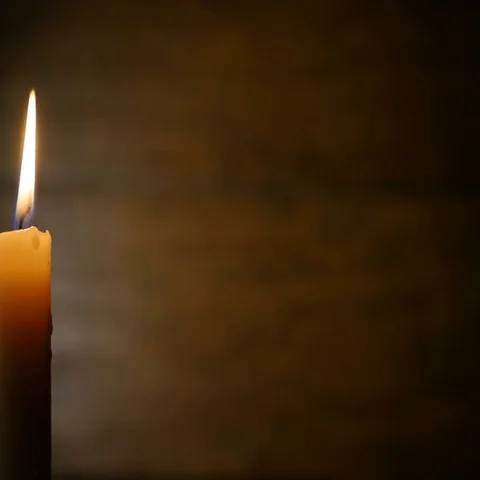 Burning Candle on a Dark Background Stock Footage 69378378