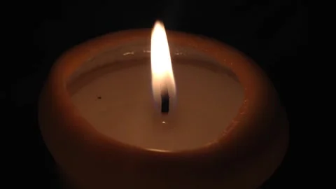 Burning candle on a dark background Stock Footage 99079983