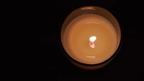 A burning candle on a dark background Stock Footage 148044783