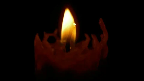 A burning candle on a dark background Stock Footage 257662376