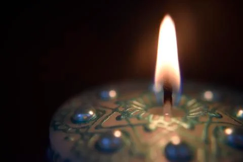 Burning candle on the dark background Stock Photos