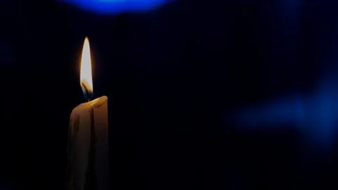 Burning candle with dark background Stock Photos