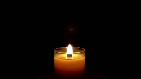 Burning candle on a dark background.Romantic evening. Stock-Footage 172542092