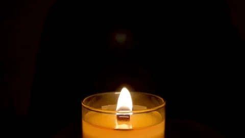 Burning candle on a dark background.Romantic evening. Stock Footage 184563091