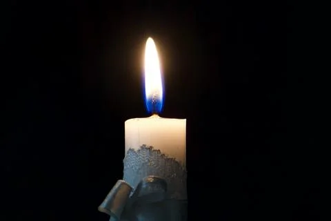 Burning candle in the dark on the eve of Easter Stock Photos