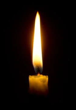Burning candle in the dark Stock Photos