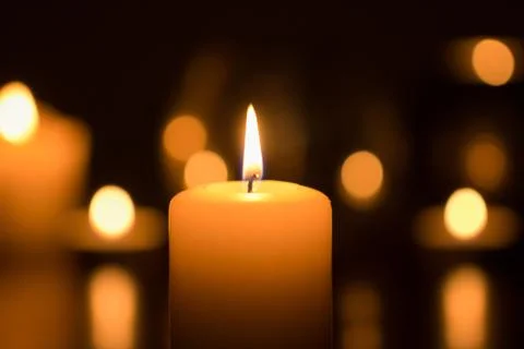 Burning candle in dark Stock Photos
