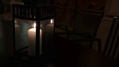 Burning candle in the dark on a table in outdoors cafe.. Video stock 124246089