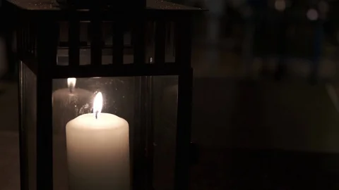 Burning candle in the dark on a table in outdoors cafe.. Stock Footage 124246197