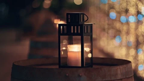 Burning candle in decorative box lighting in street at blurred background with Stock Footage 148269282