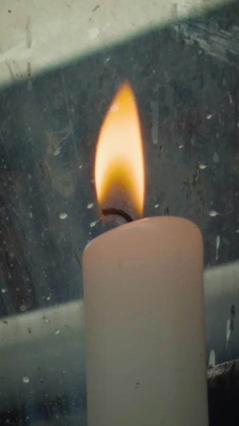 Burning candle flame behind textured glass at Japanese shrine Stock Footage 346064562