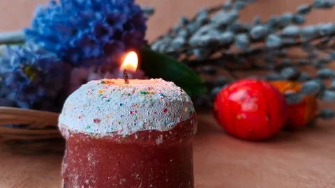 Burning candle, flowers, easter eggs Stock Footage 104849655