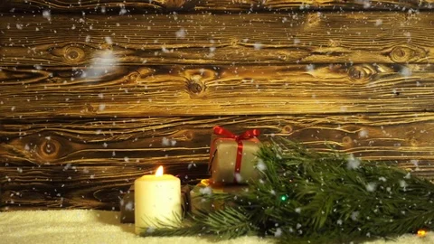 A burning candle, a fur-tree branch and gift boxes on a background of the Stock Footage 83008677