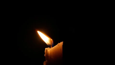 Burning candle isolated on black or dark background Stock Footage 306773563