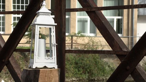Burning candle in a lantern on an empty bridge Vídeos de archivo 96101583