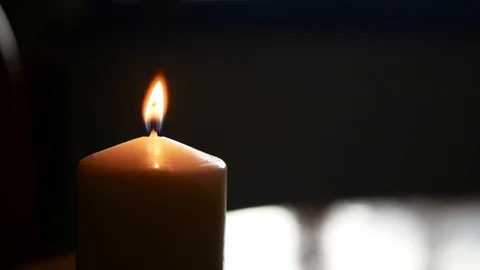 Burning candle light on dark room, light from window Stock Footage 113383239