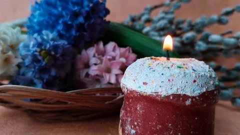 Burning candle made in the form of an Easter cake Stock Footage 104849656