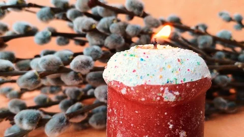Burning candle made in the shape of an Easter cake Stock Footage 104821742