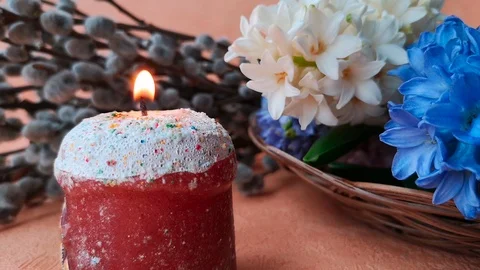 Burning candle, made in the shape of Easter cake, hyacinths and willow Stock Footage 104849686