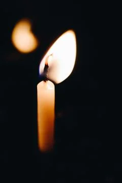 Burning candle making light in view as a background Stock Photos