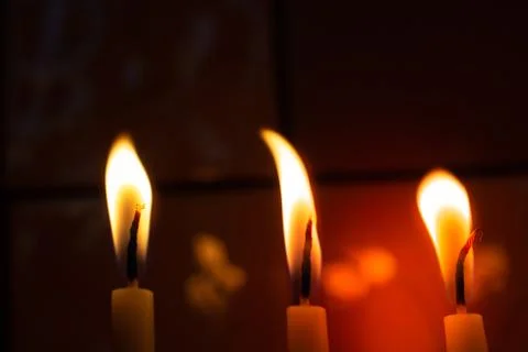 Burning candle making light in view as a background Foto stock