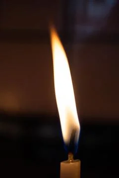 Burning candle making light in view as a background Foto stock