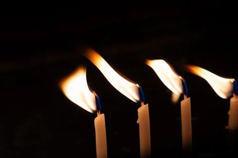 Burning candle making light in view as a background Stock Photos