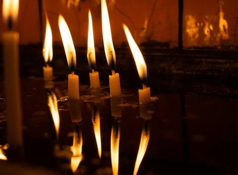 Burning candle making light in view as a background Stock Photos