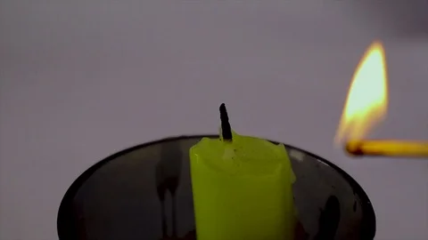 Burning a candle with a match on a white background Vídeo Stock 111375770