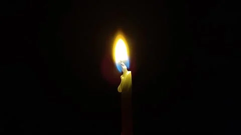 The burning candle is in the middle of the darkness Stock Footage 317900965