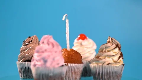 Burning candle on a muffin being extinguished Stock Footage 96442620