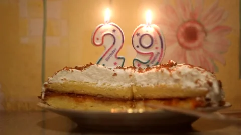 Burning candle numbers on cake 29 Stock Footage 154208810
