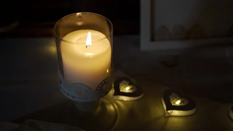 Burning candle. One large candle and small candles in the form of hearts. Stock Footage 247124070
