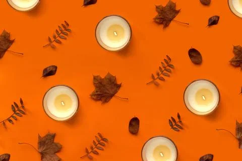 Burning candle on orange background pattern. Halloween autumn and thanksgiving Stock Photos