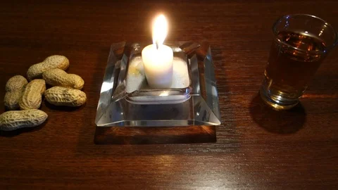Burning candle with peanuts and brandy, Christmas atmosphere Video stock 107785058