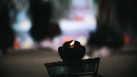 Burning candle with people dancing in the background Stock Footage 146598704