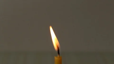 Burning candle on a plain background Stock Footage 125129226