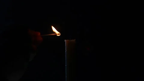 Burning candle prayer sorrow one candle burns lights up set fire to match Stock Footage 131392995