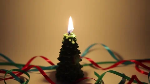 Burning candle with quivering flame in shape of fir tree Stock Footage 143660287
