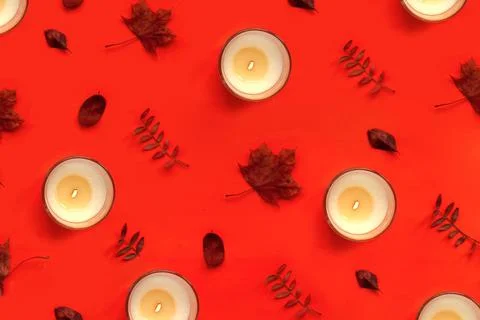 Burning candle on red background pattern. Halloween autumn and thanksgiving day Foto stock