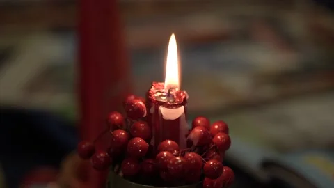 Burning candle in the red berries Stock Footage 197104214