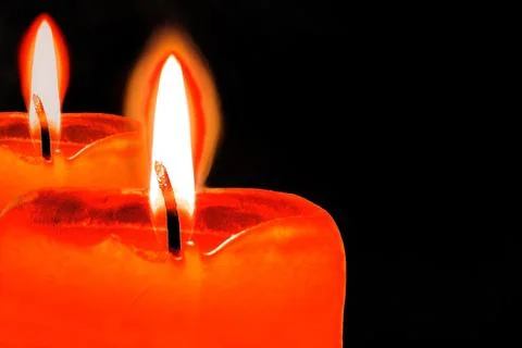 Burning candle with reflection or pair of candles with flame on black 스톡 사진