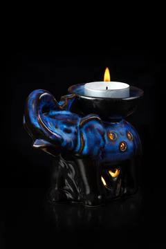 Burning candle in the shape of an elephant Stock Photos