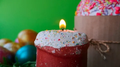 Burning candle, shiny Easter eggs and Easter cake on green screen background Stock Footage 105926245
