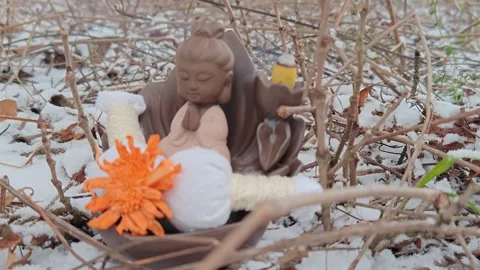 Burning candle on snow, incense smoke and herbal bags Stock Footage 324993732