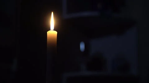 Burning candle on the table against the background of household items Stock Footage 242542796