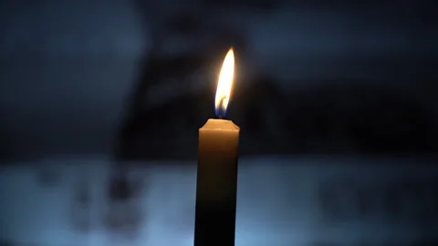 Burning candle on the table against the background of household items Stock Footage 242542848