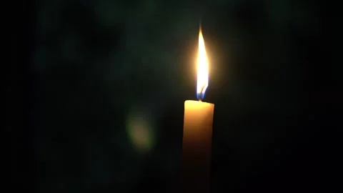 Burning candle on the table against the background of the yard Stock Footage 242543207