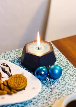 Burning candle on the table Stock Photos