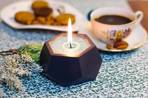 Burning candle on the table Stock Photos